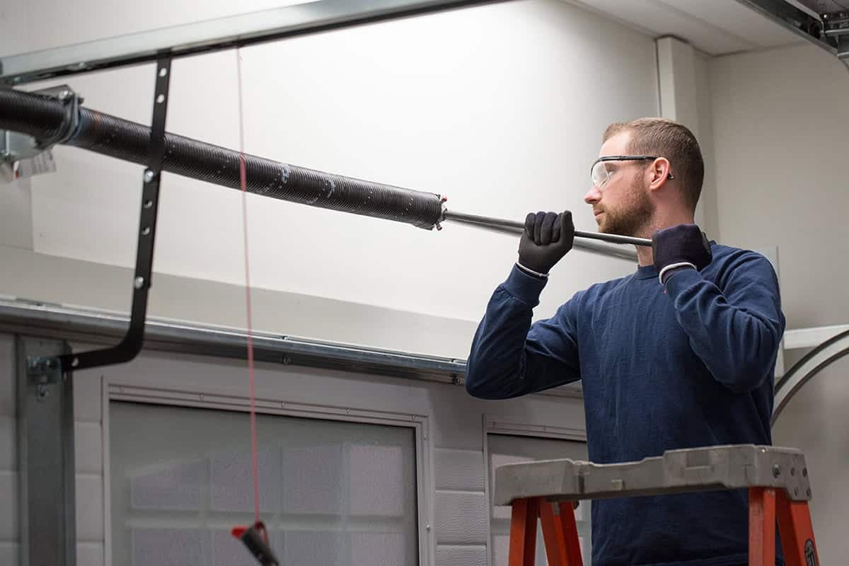 Garage Door Technician doing a Spring Repair in Orange Conty